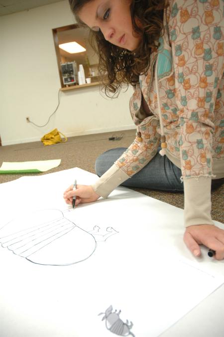 Sophomore Mallory Carter draws an armadillo during Day of Remembrance for this year's J-Crib Ministry banquet.  - Photo by Neisha Fuson
