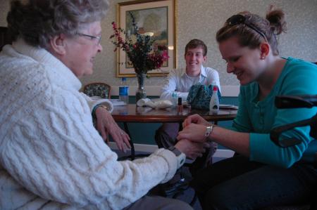 Junior Sarah Eastin and sophomore Ben Peacock visit with residents of Cheyenne Trace on Day of Remembrance.  - Photo by Neisha Fuson
