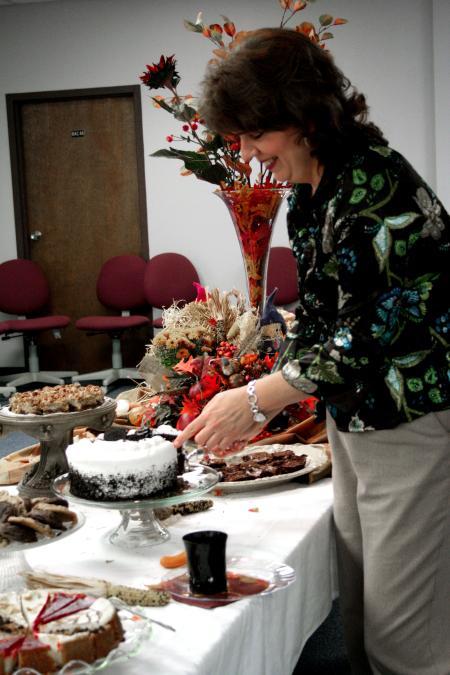 Patti Todd cuts a piece of cake at the School of Education's homecoming reception. - Photo by Kristi McMurry Woody