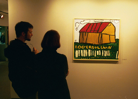 Students examine the work of Roger Sullivan at the artist's reception. - Photo by Jim Veneman