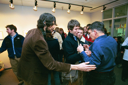 Students and alumni congratulate Roger Sullivan on his art show. - Photo by Jim Veneman