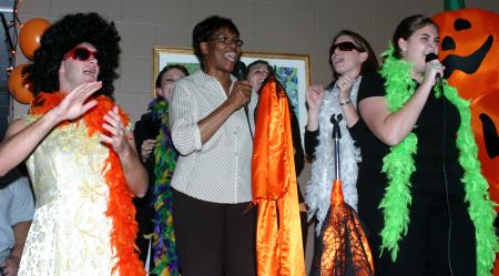 Patricia Porter sings a Tina Turner song with Andrew Courtner and Chi Omega during the Costume Coffee House. - Photo by Stephanie Schroeder
