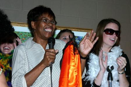 Patricia Porter sings a Tina Turner song with Chi Omega during the Costume Coffee House. - Photo by Stephanie Schroeder