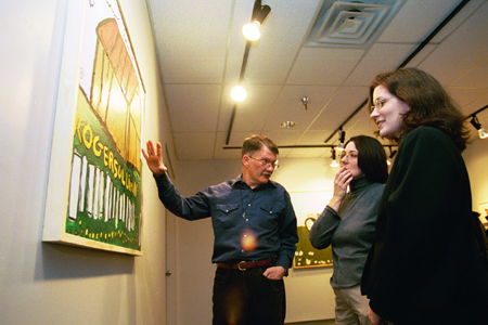 Artist Roger Sullivan takes the opportunity to explain his work to students during his artist's reception. - Photo by Jim Veneman