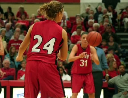 Union sophomore Laura Crittendon (24) passes the ball to Merideth Richardson Jacobs (31)during Union's Homecoming win over Harris-Stowe State College (Mo.). - Photo by Kristi McMurry Woody