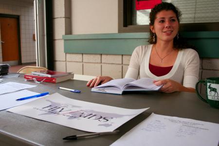Abigail Calvert, sophomore intercultural studies major, helped out at the table outside of Coburn that raised AIDS awareness and took up donations. - Photo by Kristi McMurry Woody