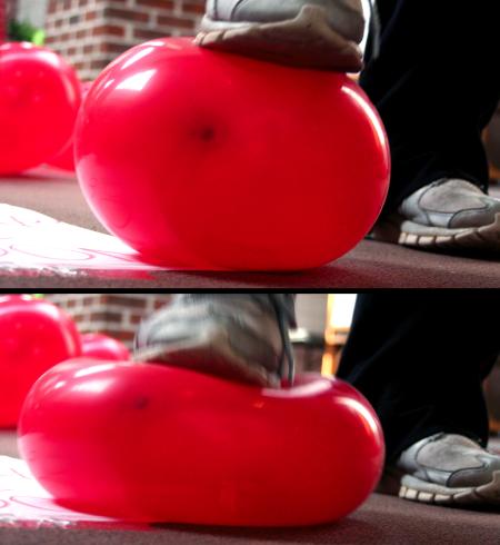 Students popped balloons outside of Coburn cafeteria.  Inside these balloons was a strip of paper encouraging students to visit the AIDS awareness booth to learn how they could help the cause. - Photo by Kristi McMurry Woody