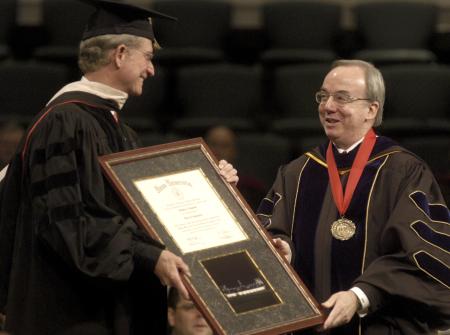 President Dockery presents the Doctor of Humanities award to Stephen C. Reynolds at December Graduation. - Photo by Jordan Buie