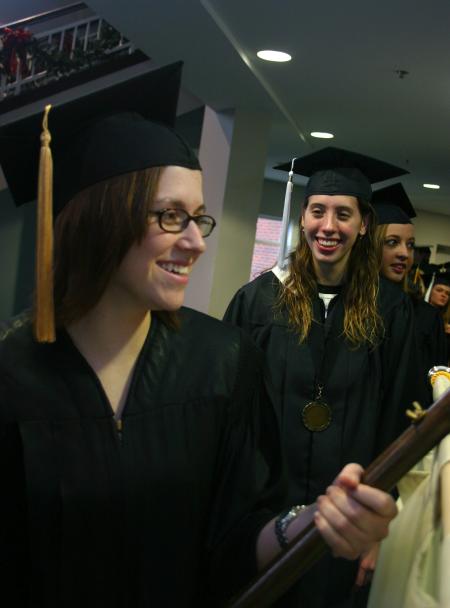 Senior Class President Jill Casey leads the way as Art graduate Heather Couch and the Fall 2007 graduates follow her in the processional. - Photo by Stephanie Schroeder