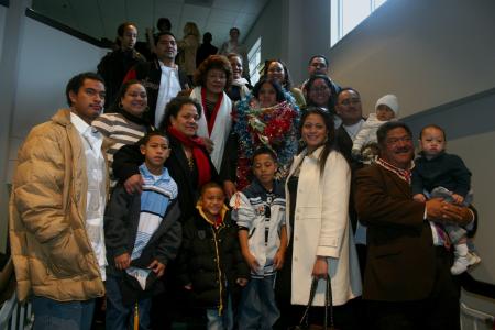 Monica Schirmer (center with leis) and her family show their support at fall graduation. - Photo by Stephanie Schroeder