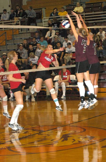 Junior Lady Bulldog CJ Neathamer spikes the ball through the Freed-Hardeman defense as Amanda Hutchison Coyle looks on during a game held at Freed-Hardeman University. 
 - Photo by Matthew Diggs