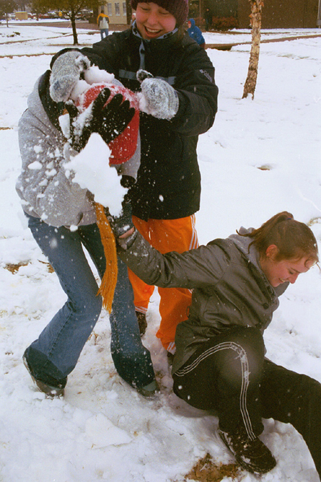 Freshmen Beth Pierce, Jill Hickman, and Cindy Keegan have fun playing in the snow. - Photo by Lindsay Stavish