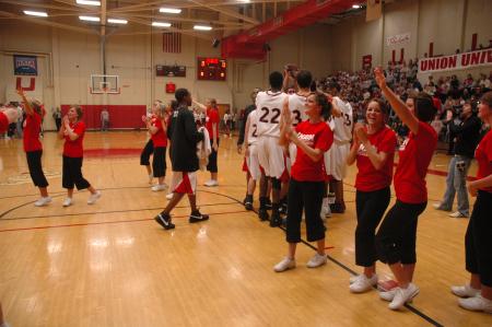 Excited to be back in their home gym, the Bulldogs and the cheerleaders celebrate.  - Photo by Neisha Fuson