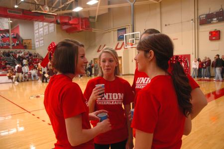 Union Cheerleaders socialize during half-time of a game against Freed Hardeman University.  - Photo by Neisha Fuson