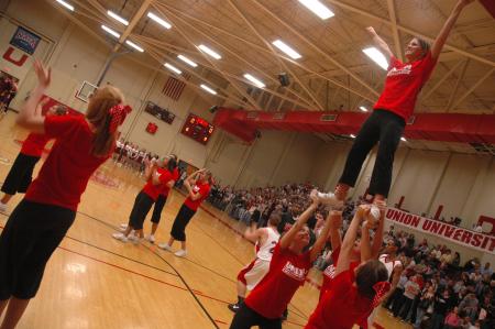 Welcoming in the team, Union cheerleaders do some stunts.  - Photo by Neisha Fuson
