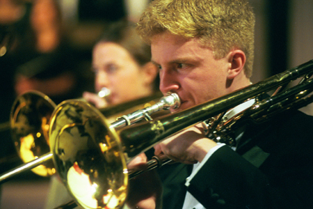 Andy Morris plays his trombone in the Symphonic Band during <i>A Union Christmas.</i>
 - Photo by Jim Veneman