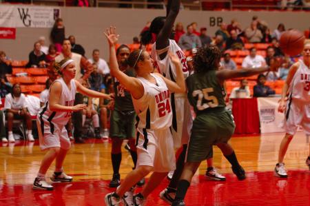 Freshmen Zeinab Chan (33) and Laura Crittendon (24) work together to block their opponents in the NAIA.  - Photo by Neisha Fuson