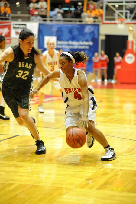 Junior Jessica Graves drives against University of Science and Arts (Okla.) during the first round of the NAIA national tournament. - Photo by Morris Abernathy