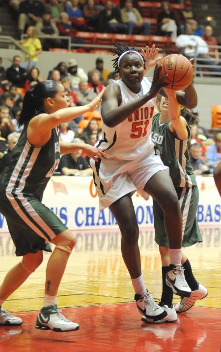 Junior Josephine Owino drives the lane during the first round of the NAIA national tournament. - Photo by Morris Abernathy