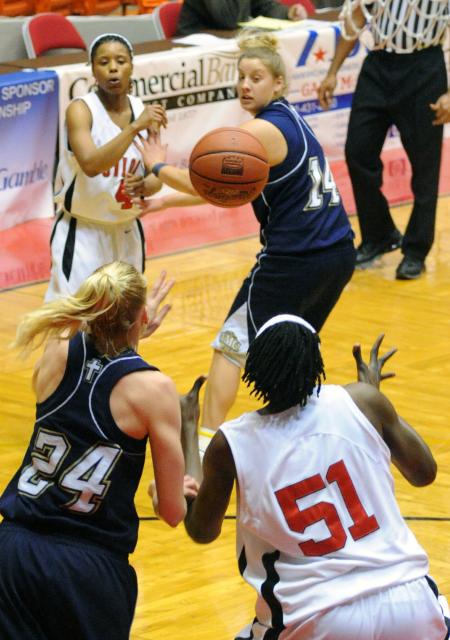 Jessica Graves makes an interior pass to Josephine Owino during the second round of the NAIA national tournament. - Photo by Morris Abernathy