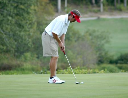 Gary Glapa gets in his putting stance during play at Falcon Ridge Golf Club. - Photo by Steven Aldridge