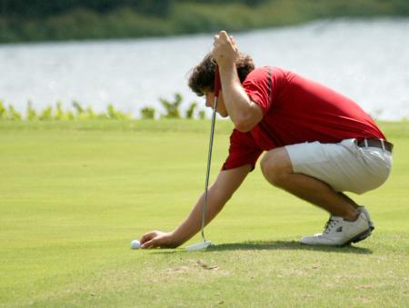 Jake Carroll places the ball on the marker as he prepares for his put. - Photo by Steven Aldridge
