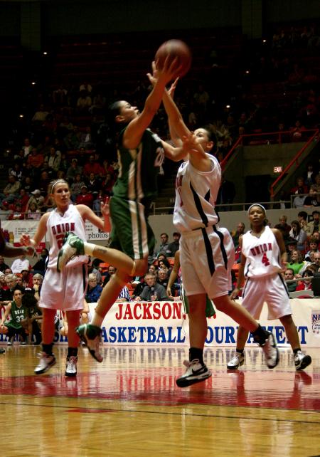 Kaitlin Dudley goes up for a rebound against her opponent from the University of Sciences and Arts during the first round of the NAIA tournament. - Photo by Kristi McMurry Woody