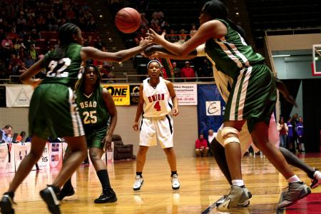 Jessica Graves watches players scramble for the loose ball during the opening round of the NAIA Division I Women's Basketball National Championship at Oman Arena.  The Lady Bulldogs defeated the University of Sciences and Arts 95-66. - Photo by Kristi McMurry Woody