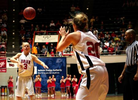 Crystal Eason passes the ball to Kayla Hudson early in the second round game against The Master's for the NAIA tournament.  The Lady Bulldogs would go on to win. - Photo by Kristi McMurry Woody
