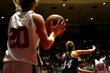 Kayla Hudson prepares to throw the ball in to Zeinab Chan who is being guarded during the second round NAIA game against The Master's. - Photo by Kristi McMurry Woody