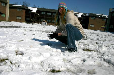 Snow covered Union's campus the night of Mar. 7, and students took a break from studying to play in it. Sophomore Heather Songer prepares a snowball as she participates in a snowball fight.  - Photo by Stephanie Schroeder