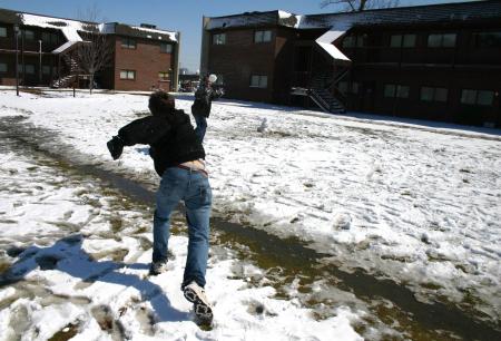 Snow covered Union's campus the night of Mar. 7, and students took a break from studying to play in it. Sophomore Matt Kuchem throws a snow ball in McAfee's courtyard. - Photo by Stephanie Schroeder