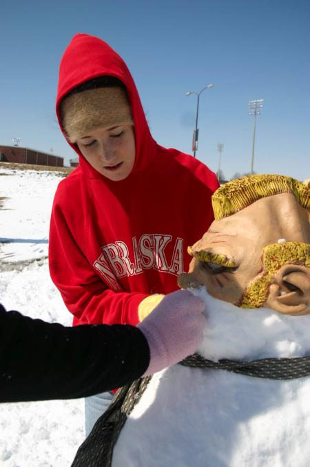 Snow covered Union's campus the night of Mar. 7, and students took a break from studying to play in it.  Sophomore Bekah Smith makes a unique snowman. - Photo by Stephanie Schroeder