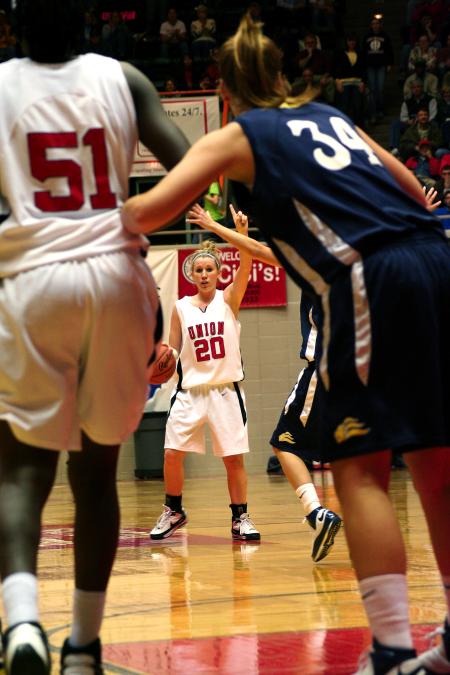 Kayla Hudson looks for an open player while calling a play.  Josephine Owino waits under the basket for an opportunity to score during the semi-final game of the NAIA tournament against Vanguard. - Photo by Kristi McMurry Woody