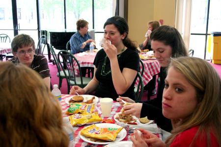 Kayla McKinney, sophomore learning foundations major, laughs at a table with her friends during the barbeque lunch provided and prepared by the team at Gwatney Chevrolet in response to the February 5 storms. - Photo by Kristi McMurry Woody