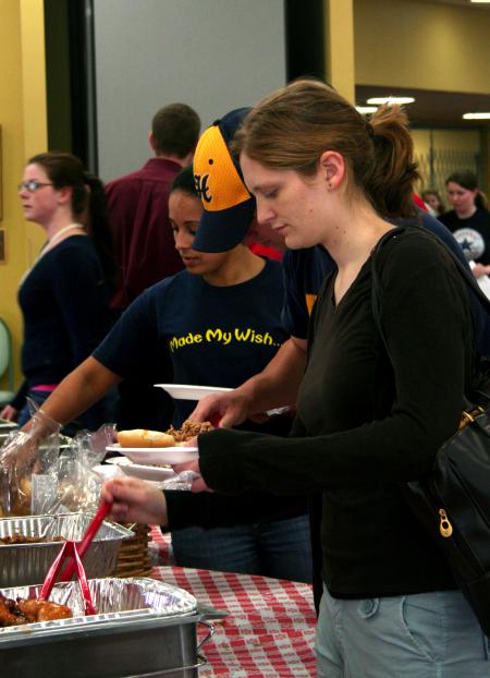 Mary Olson, sophomore teaching English as a second language major, gets her barbeque plate at the lunch provided and prepared by the team at Gwatney Chevrolet.  Gwatney Chevrolet's barbeque placed first at Memphis in May 2005. - Photo by Kristi McMurry Woody
