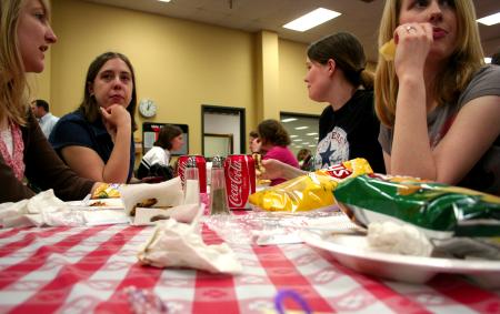 Racheal Pressnell, senior English major, Nellene Benhardus, senior English major, Heather Kapavik, junior English major, and Rachael Kapavick, sophomore DMS major, enjoy the atmosphere at the barbeque lunch provided and prepared by the team at Gwatney Chevrolet in Memphis, TN. - Photo by Kristi McMurry Woody