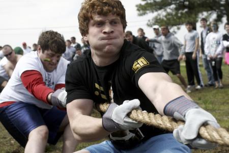 Will Hayden and Devin Maddox and fellow LXA brothers fight to regain lost ground in the tug-of-war event at the Greek Olympics. - Photo by Kyle Kurlick
