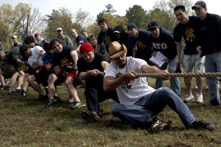 Members of ATO struggle to win the tug-of-war competition at the Greek Olympics while their brothers cheer them. - Photo by Kyle Kurlick