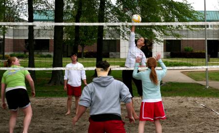 Chanel Watson, sophomore public relations/advertising major spikes the ball during the volleyball tournament that helped raise money for the disaster relief fund.  - Photo by Kristi McMurry Woody