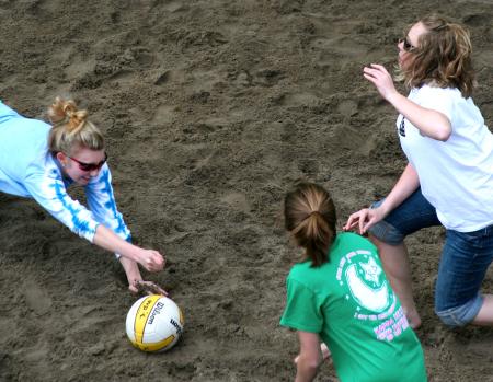 Bekah Long, senior psychology major, dives for the ball while her teammates run to help her during the volleyball tournament that helped raise money for the disaster relief fund. - Photo by Kristi McMurry Woody