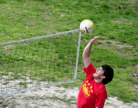 Todd Buck, sophomore accounting major, hits the ball over the net during the volleyball tournament that raised money for the disaster relief fund. - Photo by Kristi McMurry Woody