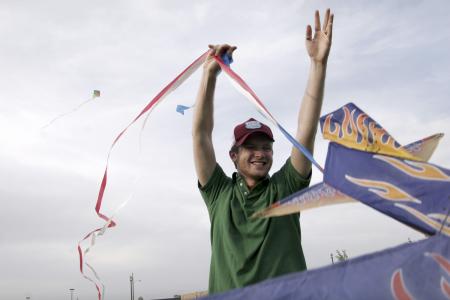 Matt Taylor tries to get a kite up in the air during May Day out on the great lawn by Miller Tower. Besides flying kites, students enjoyed several inflatable play arenas and free snow cones. - Photo by Kyle Kurlick
