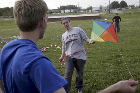 Elisabeth Crecink helps Matt Morse get his kite up in the air during May Day. - Photo by Kyle Kurlick