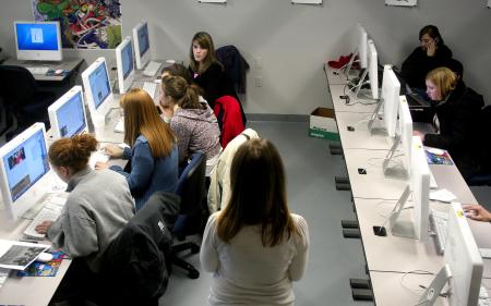 Students on the Cardinal and Cream staff work on the paper in the temporary DMS lab.  The DMS lab will be moved back to Jennings Hall when construction is completed in the fall. - Photo by Kristi McMurry Woody