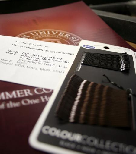 Programs, instructions, and bobby pins were left behind after the graduates excitedly rushed to line up for graduation in the Fred Delay gymnasium. - Photo by Kristi McMurry Woody