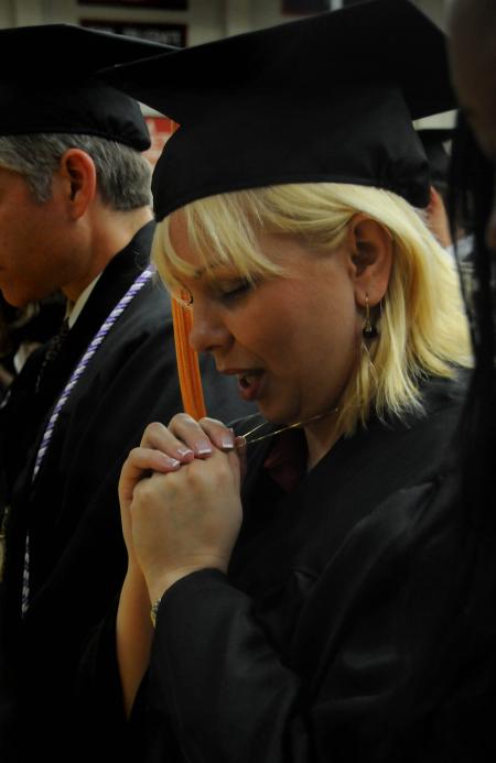 Doris Simas, of Jackson, Tenn., prays just before receiving her Bachelor of Science in Nursing degree during the summer graduation at Union University.  - Photo by Jim Veneman
