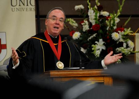 President Dockery delivers the commencement charge to the new graduates during the summer graduation ceremony in Union's Fred DeLay Gymnasium. - Photo by Jim Veneman