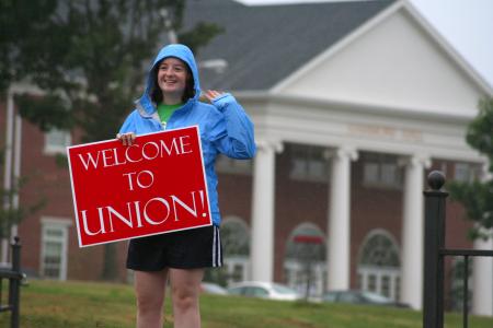 Catherine Neal, senior intercultural studies major, welcomes new students and their families to Union at the front entrance.   - Photo by Kristi McMurry Woody