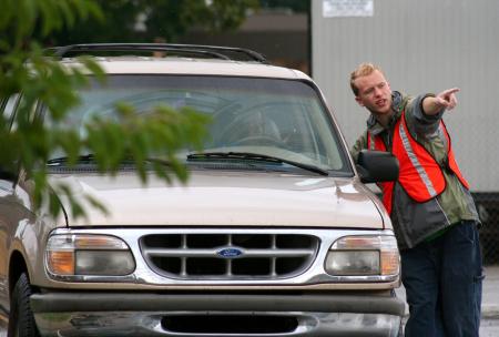 Dustin Mayfield, senior biology major, helps direct traffic during move-in day for new students. - Photo by Kristi McMurry Woody